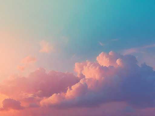 This image captures a stunning sky at either sunrise or sunset, with a gradient of colors that transition beautifully from left to right. On the left side, the sky is bathed in a warm, peachy-pink hue, gradually blending into a light blue as it moves towards the center. The right side of the sky deepens into a rich, dark blue. Scattered throughout the sky are clouds that add texture and depth to the scene. The clouds on the left side are tinged with pink, while those on the right side take on a darker blue shade. The bottom of the image features a dense layer of clouds, predominantly pink with hints of blue, creating a striking contrast against the vibrant sky above.