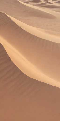 A mesmerizing photograph captures the serene beauty of a vast desert landscape. The image, taken from a slightly elevated vantage point, showcases an expansive array of sand dunes stretching as far as the eye can see. The dunes are adorned with intricate patterns and textures, created by the wind's persistent erosion. Some dunes rise prominently, while others gently slope, their contours highlighted by the interplay of light and shadow. The sand exhibits a rich palette of colors, ranging from deep browns to lighter, almost golden hues, adding depth and dimension to the scene. The overall effect is a breathtaking display of nature's artistry, inviting viewers to lose themselves in the boundless expanse of this tranquil desert vista.