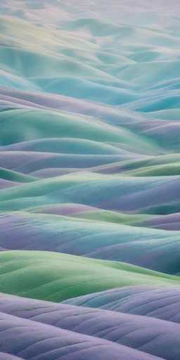 This image showcases a stunning, computer-generated landscape of rolling hills and mountains. The scene is filled with vibrant colors, predominantly greens, purples, and blues, creating a surreal and almost otherworldly atmosphere. The hills are depicted in various hues, with some areas appearing green, others blue, and some purple, giving the impression of a fantastical terrain. The mountains in the background are lighter in color, adding depth to the composition. The entire image is devoid of any text, people, or animals, focusing solely on the natural beauty of the landscape. The intricate details and vivid color palette make it a captivating and visually striking piece.