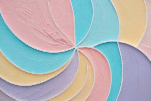 The image depicts a vibrant, abstract painting characterized by a series of overlapping, curved shapes that radiate from the center in a circular pattern. These shapes, resembling petals or leaves, are meticulously arranged in a sequence of colors: starting with pink on the left, followed by blue, yellow, purple, and repeating this sequence. The shapes are outlined in white, creating a striking contrast against the vivid hues. The painting's texture appears to be created with a thick medium, possibly paint or clay, giving it a three-dimensional quality. The background is a light brown, which further accentuates the bright colors of the shapes. The overall composition is visually captivating, with the shapes seamlessly blending into one another, creating a harmonious and dynamic visual experience.